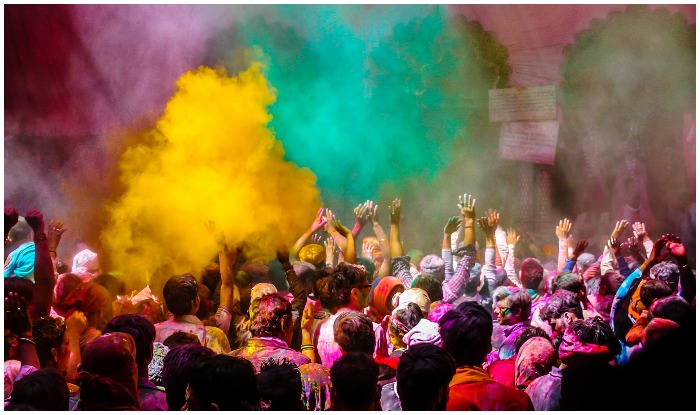 People Playing With Powder Paint On Street During Holi